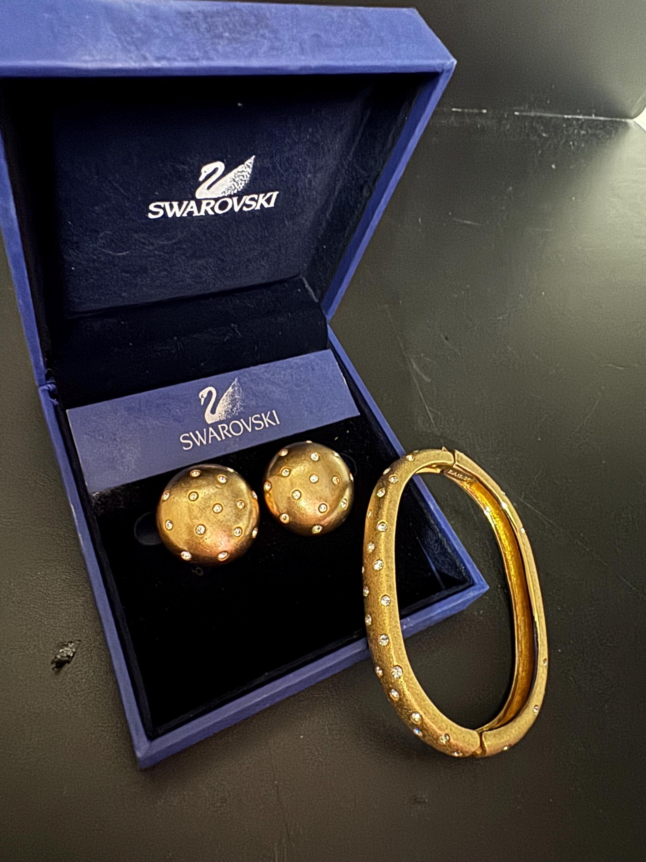 Jewellery set signed swan Swarovski crystal pave set Matt gold plated clamper bangle and matching button clip on earrings