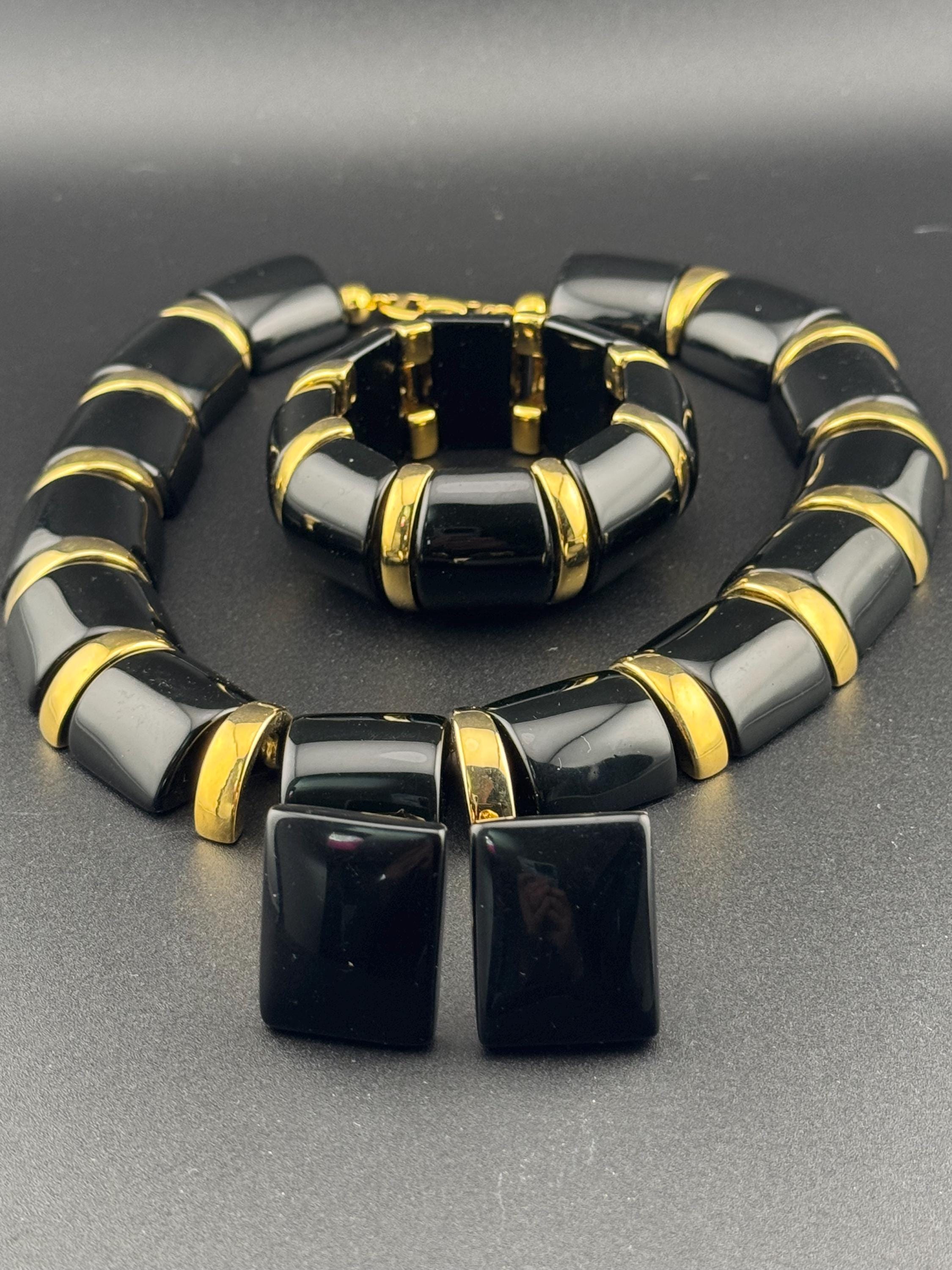 Signed NAPIER Vintage black glossy lucite gold tone panel collar necklace , stretch bracelet and clip on earrings jewellery set