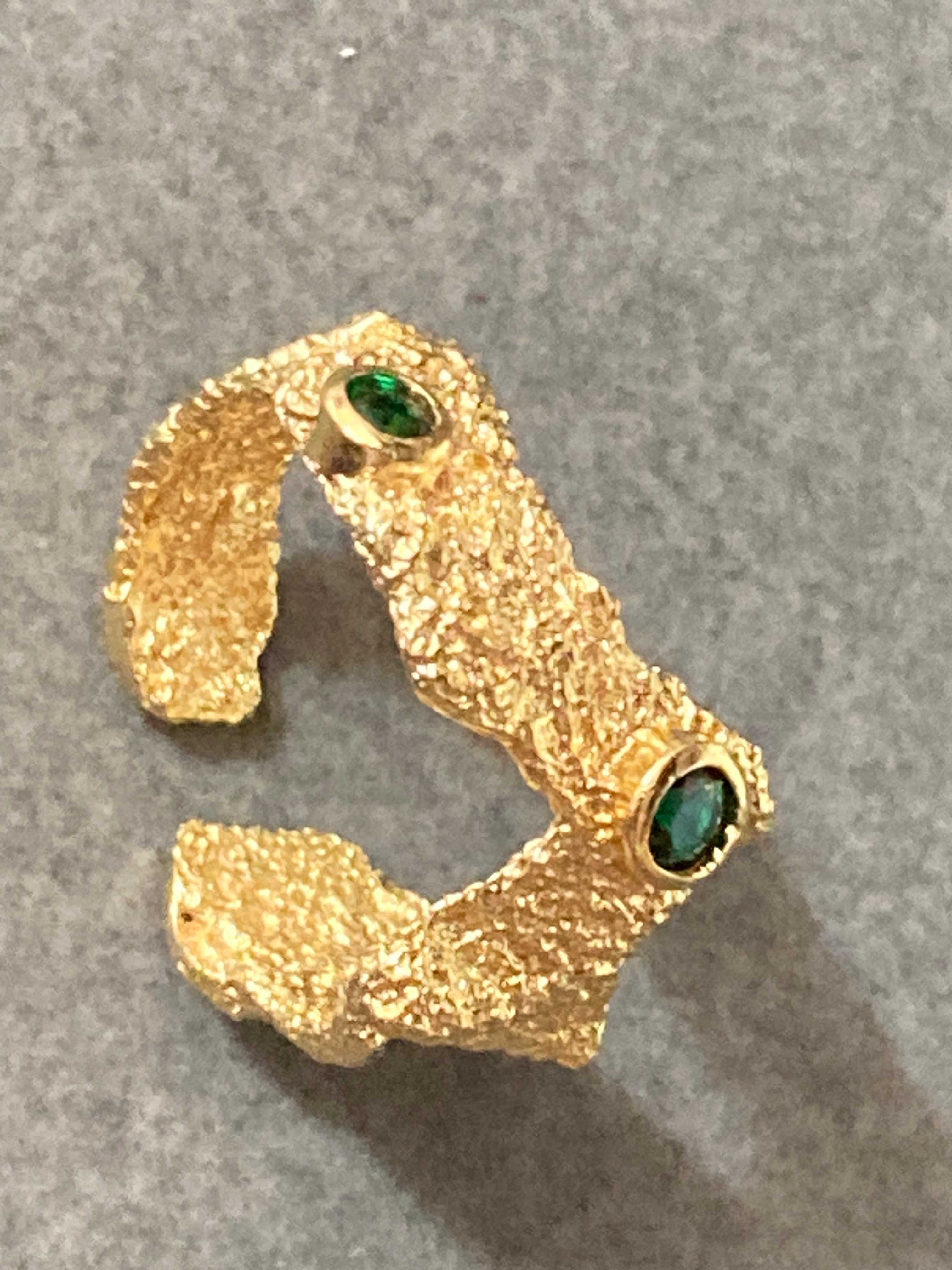 Modernist gold tone bark nugget dress ring with green stones