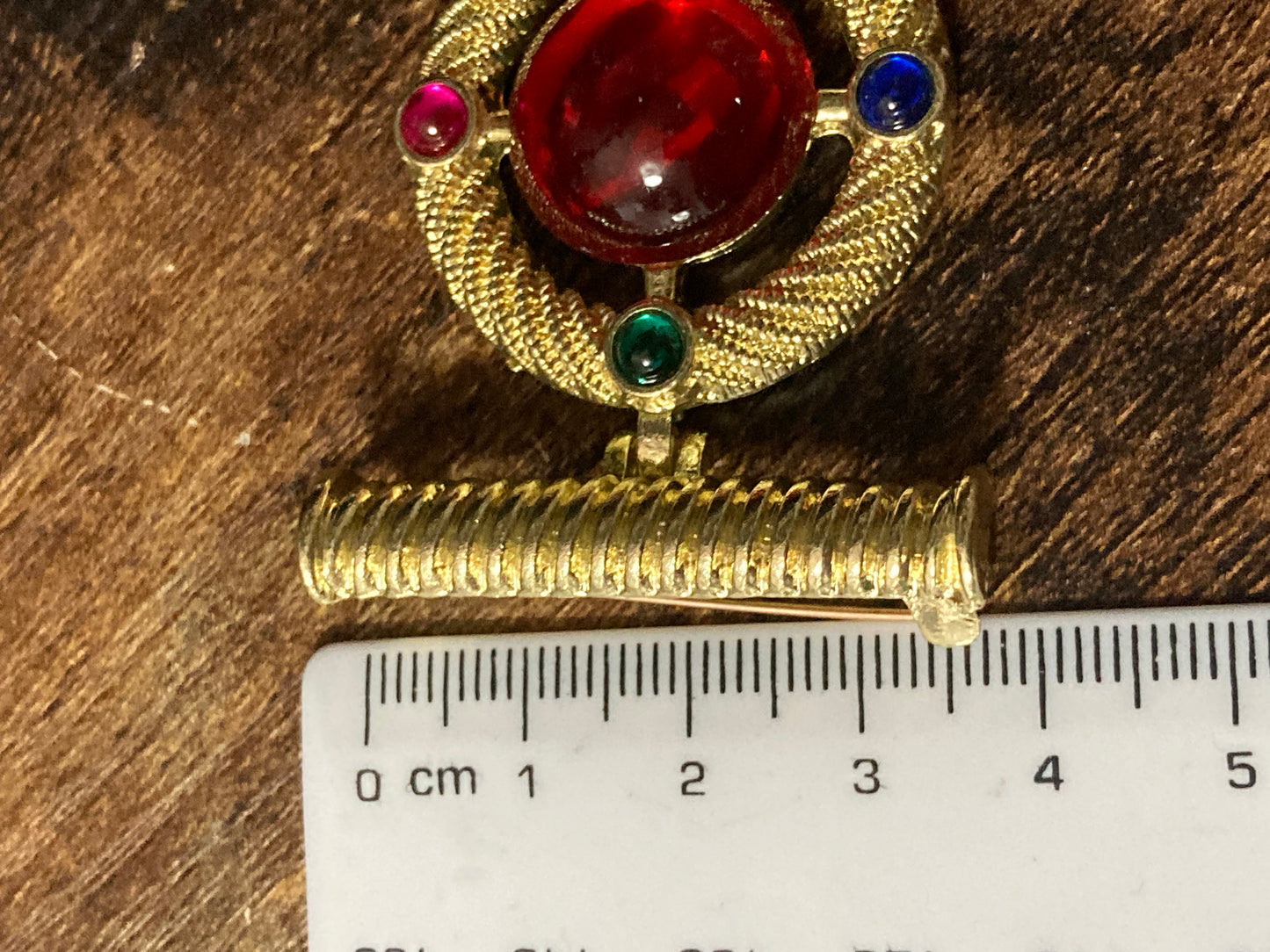 Gold medal ruby glass hanging brooch